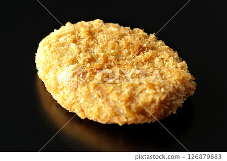 Beef croquette photographed against a black background 126879883