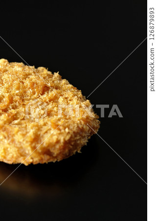 Beef croquette photographed against a black background 126879893