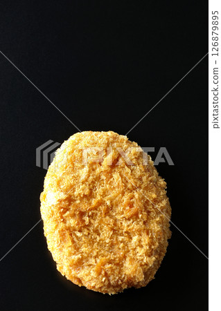 Beef croquette photographed against a black background 126879895