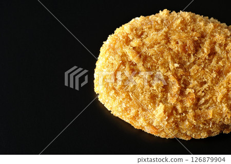 Beef croquette photographed against a black background Beef croquette photographed against a black background 126879904