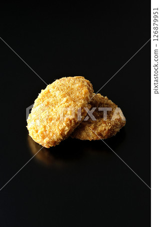 Beef croquette photographed against a black background 126879951