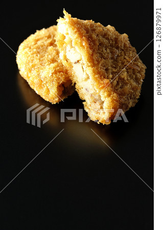Beef croquette photographed against a black background 126879971
