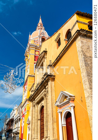 Close-up view of the Cathedral of Saint Catherine of Alexandria in Cartagena, Colombia, showcasing its colorful dome and stone facade under a vivid blue sky 126880471