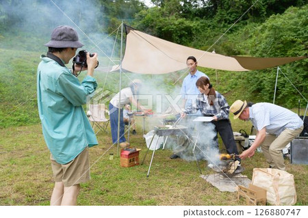 Family taking commemorative photos at a campsite 126880747