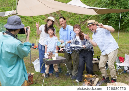 Family taking commemorative photos at a campsite 126880750