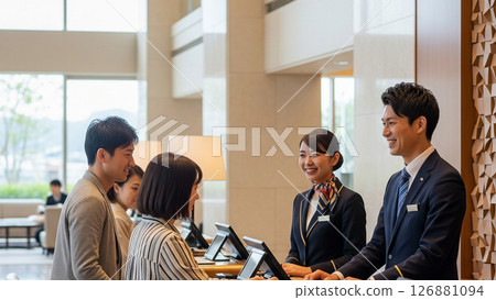 Hotel front desk staff serving customers with a smile Hotel front desk staff serving customers with a smile 126881094
