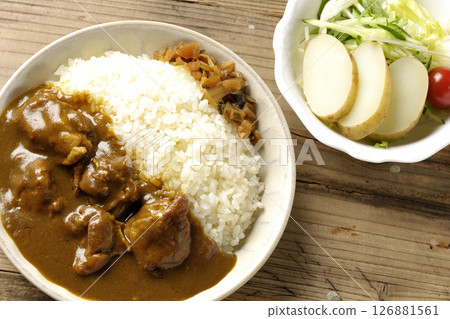 Chicken curry with chunks of chicken and potato salad 126881561