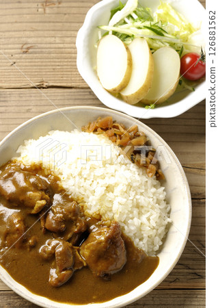 Chicken curry with chunks of chicken and potato salad Chicken curry with chunks of chicken and potato salad 126881562