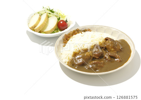 Chicken curry with chunks of chicken and potato salad 126881575
