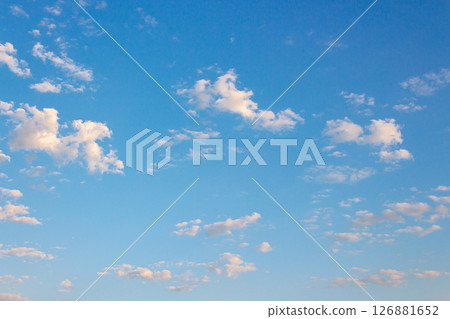 blue sky with clouds on a sunny august morning. fluffy formations in bright weather. blue nature backdrop in morning light. warm forecast background during summer 126881652