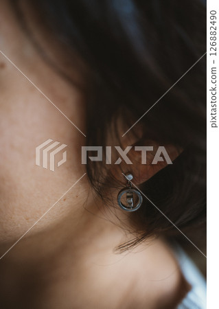 Close-Up of Baby Wearing Circular Earring Close-Up of Baby Wearing Circular Earring 126882490