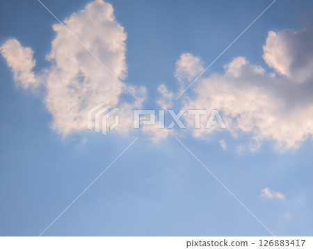 Vast blue sky with fluffy white clouds on a bright day Vast blue sky with fluffy white clouds on a bright day 126883417