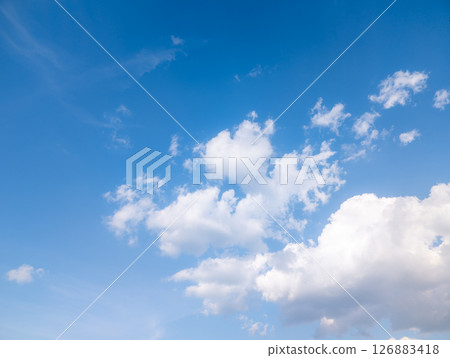Vast blue sky with fluffy white clouds on a bright day Vast blue sky with fluffy white clouds on a bright day 126883418