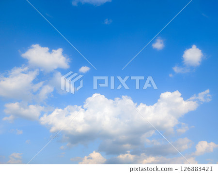 Vast blue sky with fluffy white clouds on a bright day Vast blue sky with fluffy white clouds on a bright day 126883421