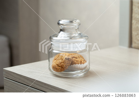 Cookies in a jar hint at a sweet break in a quiet corner. Cookies in a jar hint at a sweet break in a quiet corner. 126883863