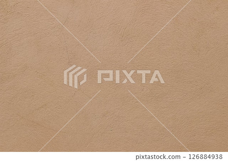 Old rough beige ochre colored cracked painted plaster wall texture. Earth coloured grunge texture, building facade. Closeup of historical house detail. Faded neutral backdrop, empty copy space. 126884938