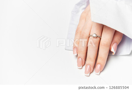 Woman hand showing french manicure and elegant ring on white background Woman hand showing french manicure and elegant ring on white background 126885504