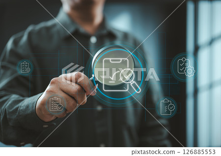 Businessman using digital magnifying glass to inspect audit and document icons 126885553