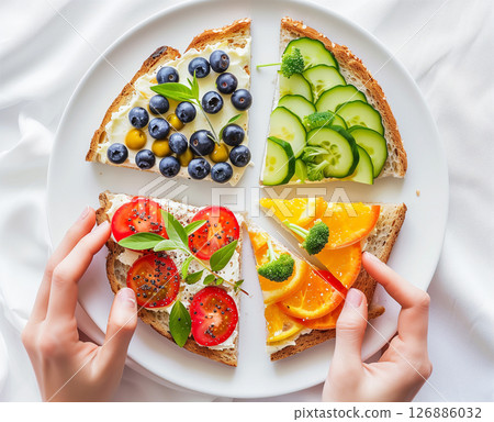 Vibrant healthy breakfast plate with colorful toasts and blueberries - top view 126886032