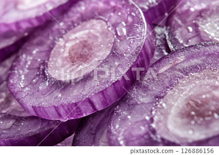 A close-up of fresh red onion slices arranged in a seamless pattern. The purple tones and detailed texture make it ideal for backgrounds, food packaging, food blogs or healthy eating campaigns. Banner 126886156