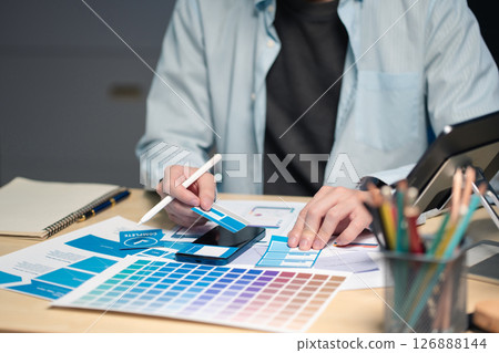 Male coder or developer working overtime using a computer display in problem solving at workplace. Male coder or developer working overtime using a computer display in problem solving at workplace. 126888144