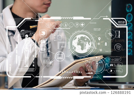 Male medicine doctor , physician or practitioner in lab room writing on blank notebook and work on laptop computer with medical stethoscope on the desk at hospital. Medic tech concept. 126888191