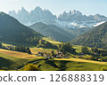 Visit Italy. Framed by towering peaks, the quiet village of Santa Maddalena glows at sunrise, a serene start to the day in the dramatic Dolomites 126888319