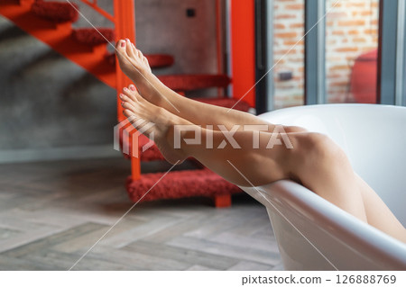 Woman feet in bathrobe at home, closeup 126888769