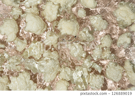 Fresh Cauliflower Dropped in Water with Splash Effect Above. 126889019