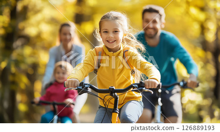 Cheerful family biking together in sunny park, enjoying outdoor fitness 126889193