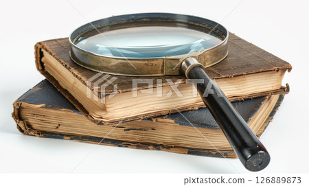 Old, weathered books and magnifying glass on a white background. Vintage literature, knowledge, history themes 126889873
