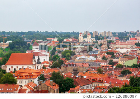Cityscape of Vilnius, Lithuania from viewpoint in a summer cloudy day. View of the old town with orange tile roofs. Famous tourist destination. Travel photography. Cityscape of Vilnius, Lithuania from viewpoint in a summer cloudy day. View of the old town with orange tile roofs. Famous tourist destination. Travel photography. 126890097