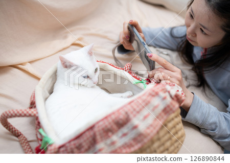 一名女子用智慧型手機為貓咪拍照 126890844