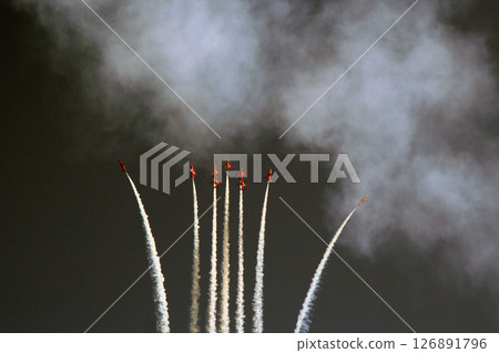 Red Arrow Aerobatic Planes Performing a High Altitude Display with Contrail Effects on isolated color Red Arrow Aerobatic Planes Performing a High Altitude Display with Contrail Effects on isolated color 126891796