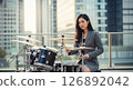Woman playing drums in the office 126892042