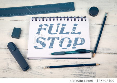 Full Stop Phrase Written on Notepad with Blue Stationery on White Wooden Background 126892109