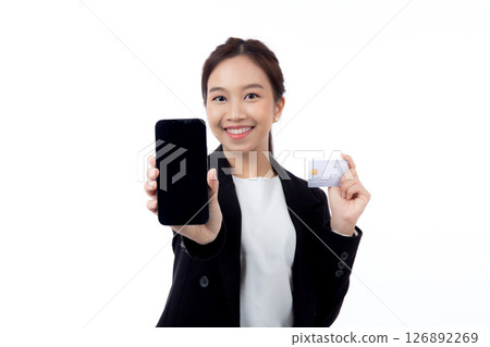 Portrait young asian businesswoman holding credit card and smartphone smiling isolated. 126892269