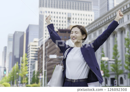 A young businesswoman stretching in an office district 126892308