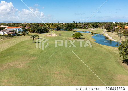 Golf club field with cart and playing golfers. Aerial view Golf club field with cart and playing golfers. Aerial view 126893210
