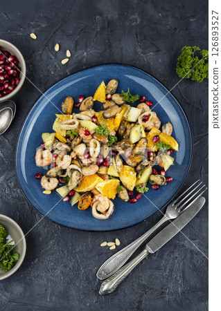 Plate of delicious fruit salad with seafood. 126893527