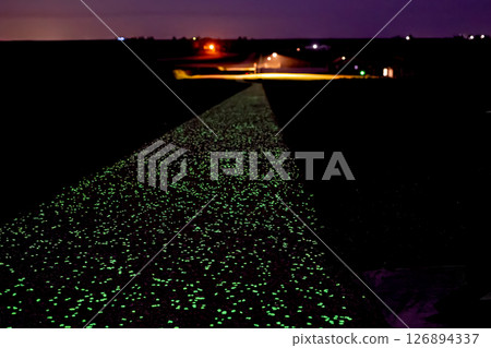 A section glow-in-the-dark concrete sidewalk along Nathan's Miles Glow Trail in Vinton, Iowa, USA 126894337