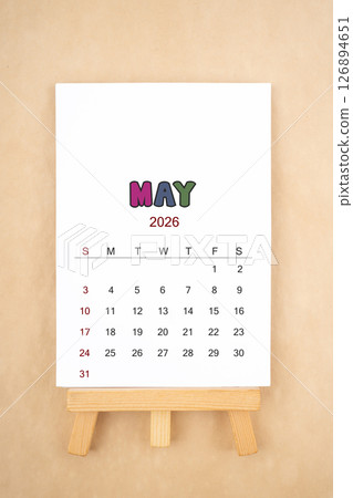 Calendar page for May 2026 with wood easel on old brown background. Calendar page for May 2026 with wood easel on old brown background. 126894651