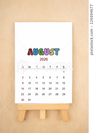 Calendar page for August 2026 with wood easel on old brown background. 126894677