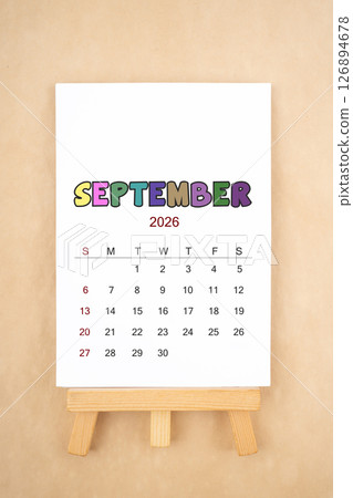 Calendar page for September 2026 with wood easel on old brown background. 126894678