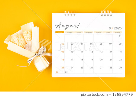 2026 August desk calendar and Yellow bouquet on yellow background. 2026 August desk calendar and Yellow bouquet on yellow background. 126894779