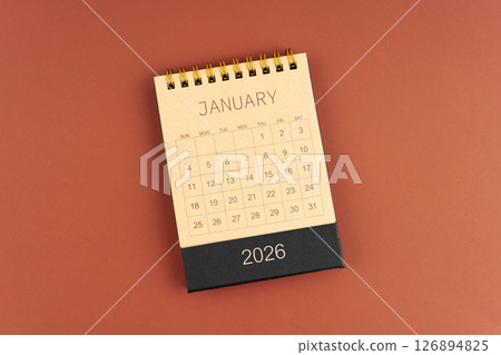January 2026 calendar from brown craft paper on red background. January 2026 calendar from brown craft paper on red background. 126894825