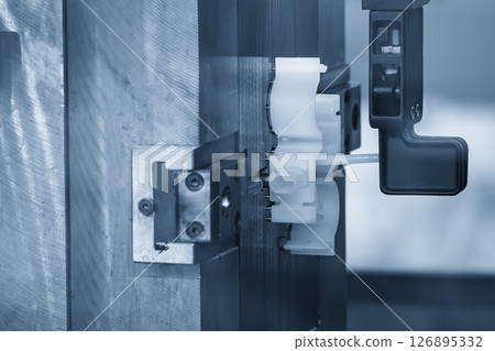 The automotive parts production process by plastic injection mold machine in the light blue scene. The automotive parts production process by plastic injection mold machine in the light blue scene. 126895332