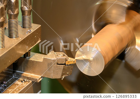 Closeup scene the lathe machine rough cut the metal parts by coating tool. Closeup scene the lathe machine rough cut the metal parts by coating tool. 126895333