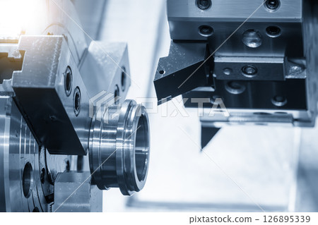 The CNC lathe machine forming cutting the metal tube parts in the light blue scene. The CNC lathe machine forming cutting the metal tube parts in the light blue scene. 126895339