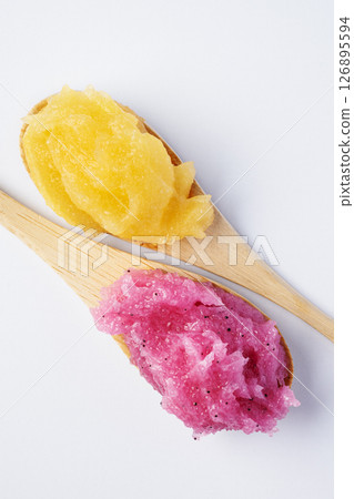 Raspberry and melon fruit scrub texture. Bright pink and yellow body care sugar scrub with exfoliating crystals. Organic cosmetic body care peeling. Natural skincare exfoliating scrubber treatment. Raspberry and melon fruit scrub texture. Bright pink and yellow body care sugar scrub with exfoliating crystals. Organic cosmetic body care peeling. Natural skincare exfoliating scrubber treatment. 126895594